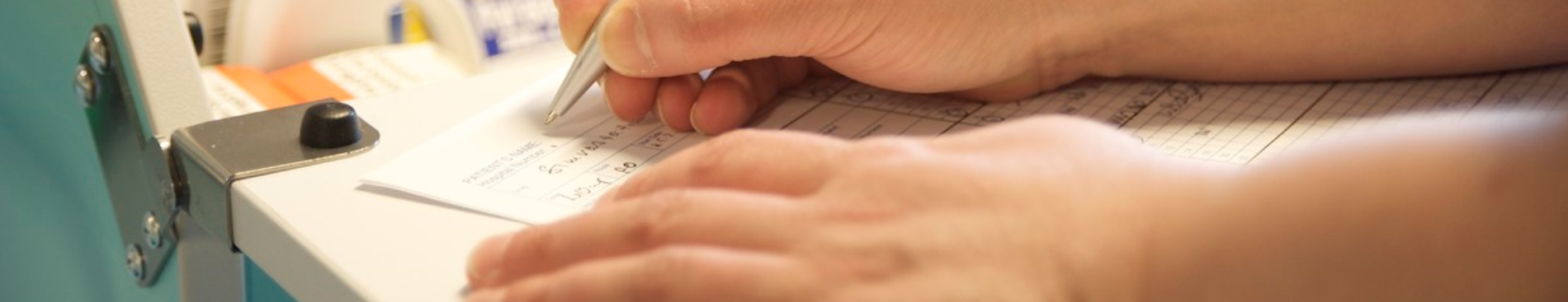 nursing staff member completing paperwork 