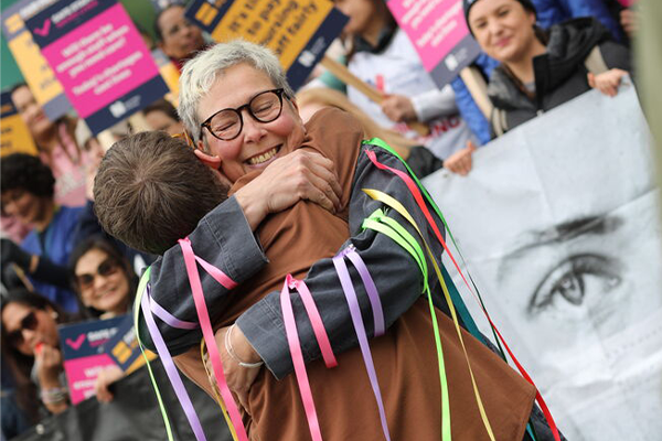 A patient and nurse hugging on a strike line
