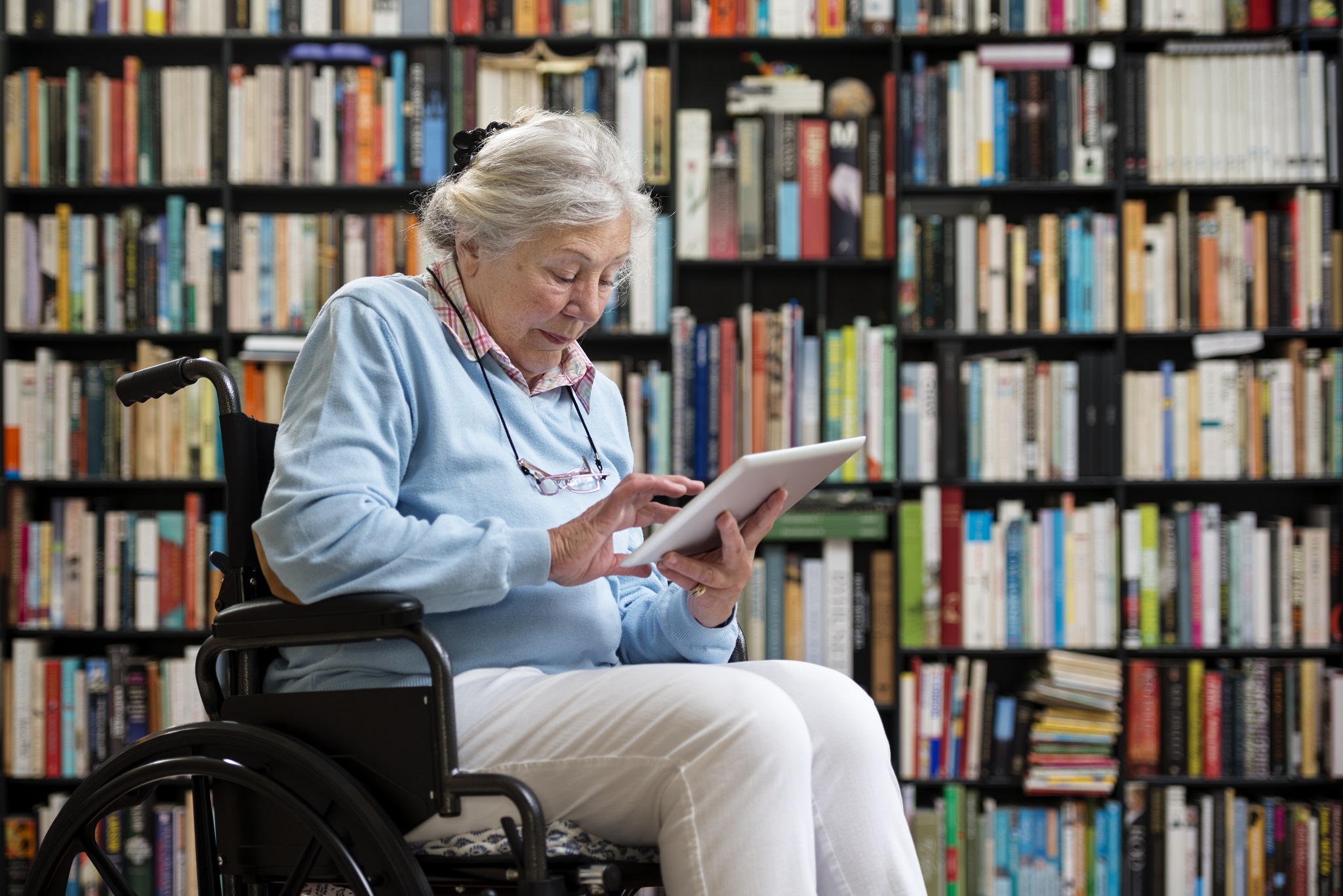Woman in wheelchair reading a book