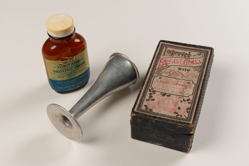 A bottle of obstetric cream, a pinard horn, and a breast pump. 