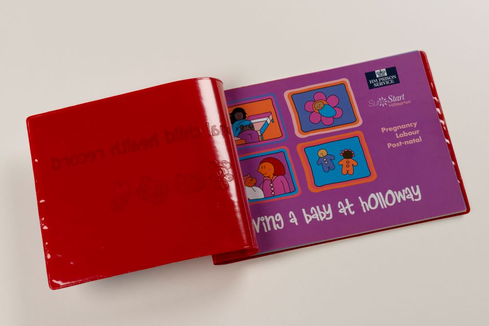 Children's health record red booklet given by midwives and nurses in prison, tailored to the prison setting.