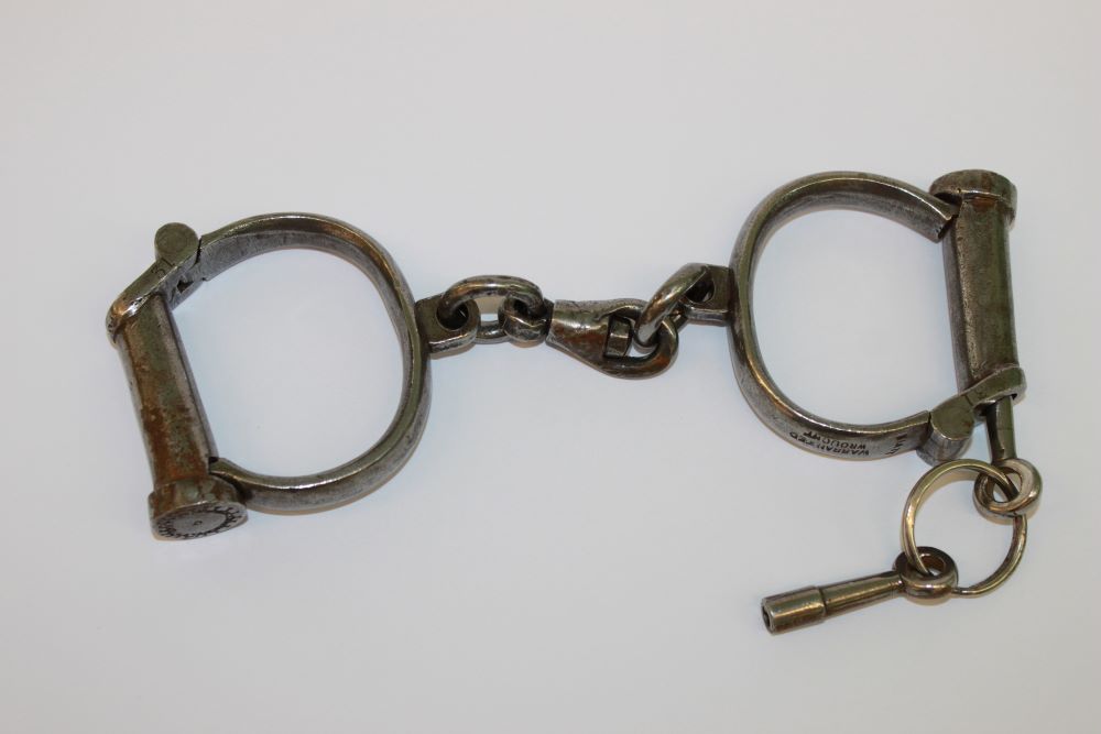 a pair of heavy metal handcuffs. 