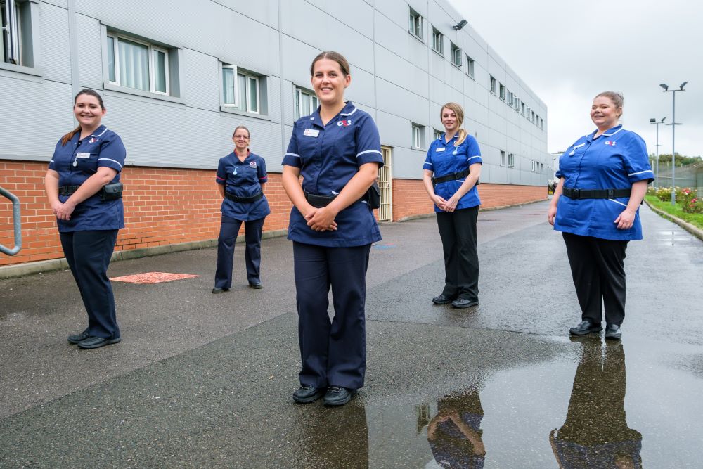 A team of five prison nurses who won a 2020 RCNi Nurse Award. They are standing outside the prison hospital socially distanced.