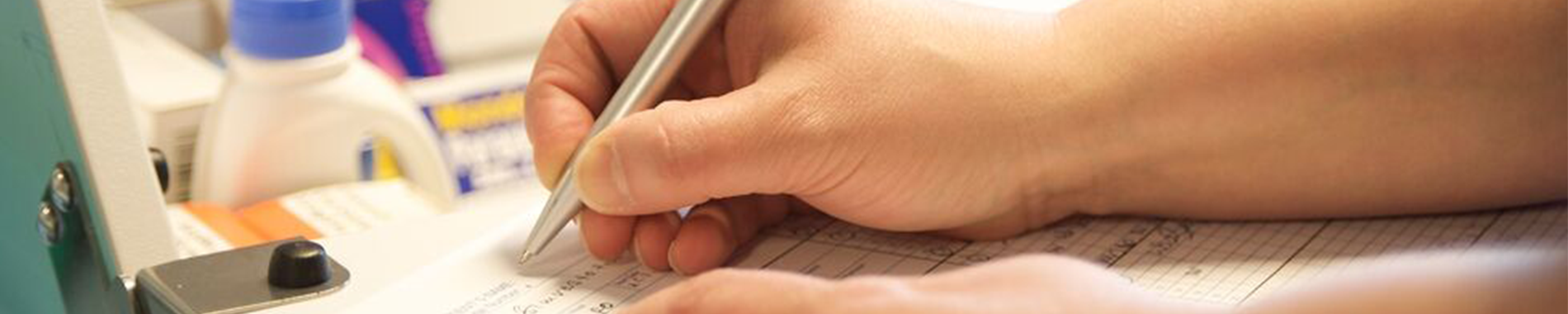 a close up nurse signing a paper