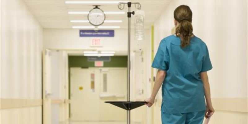 Nursing support worker walking down a corridor