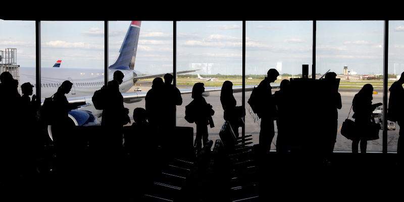 People queuing up in airport to board plane