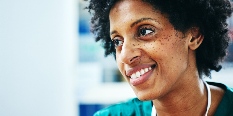 Close up of health care support worker profile facing away from camera into middle distance