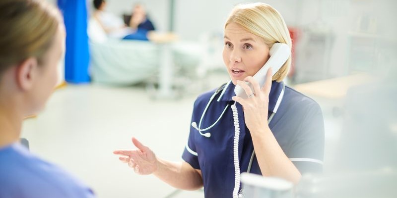 Nurse in blue uniform on the phone