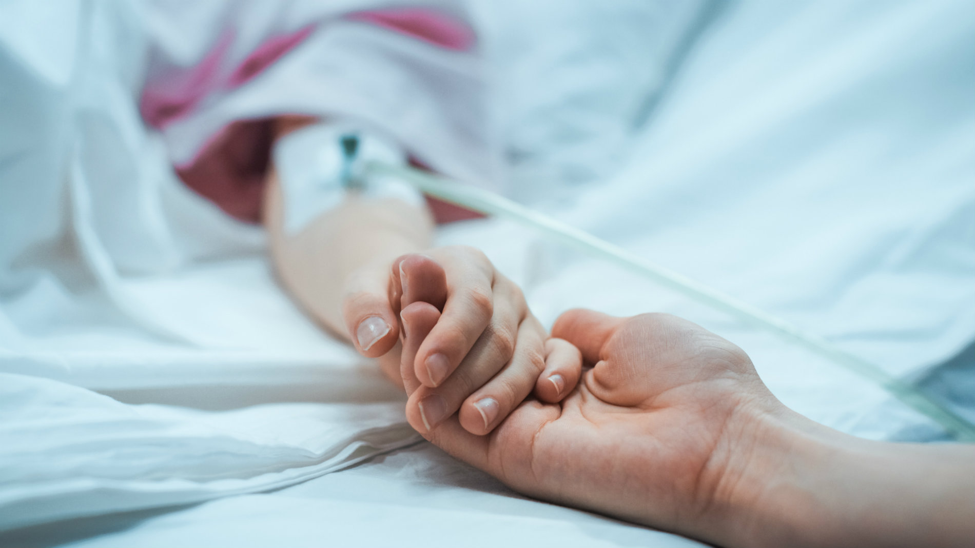 Holding child's hand in hospital
