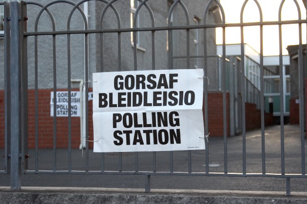 Bilingual sign on railings for a polling station in Wales
