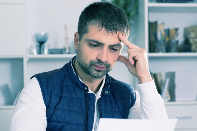 Man looking at a bill