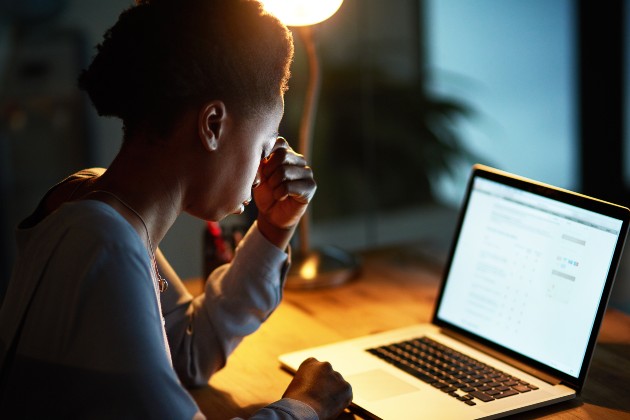 Woman looking stressed at laptop