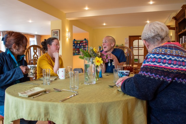 Kiera and volunteers sat around a table in the hospice