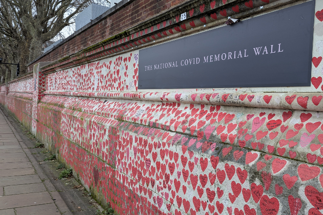 The National COVID Memorial Wall is seen in London. The wall has a large plaque with its name, and is covered in red hearts as far as the eye can see, each one representing a person who died with COVID-19 on their death certificate.