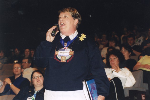 Professor Dame June Clark speaking with a microphone in her hand