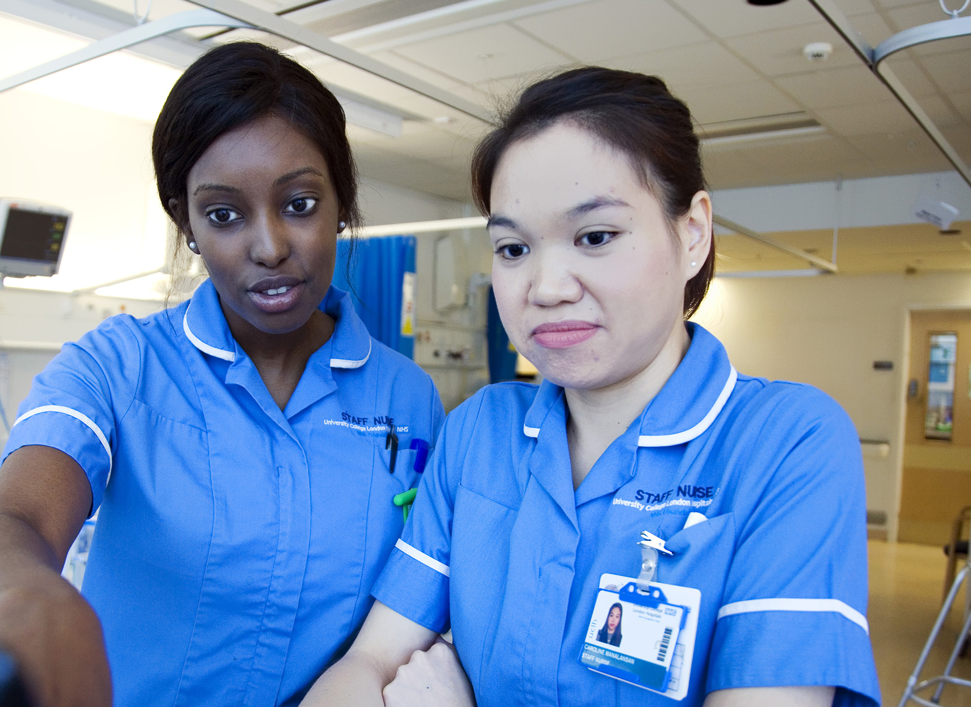 Two nurses review patient notes