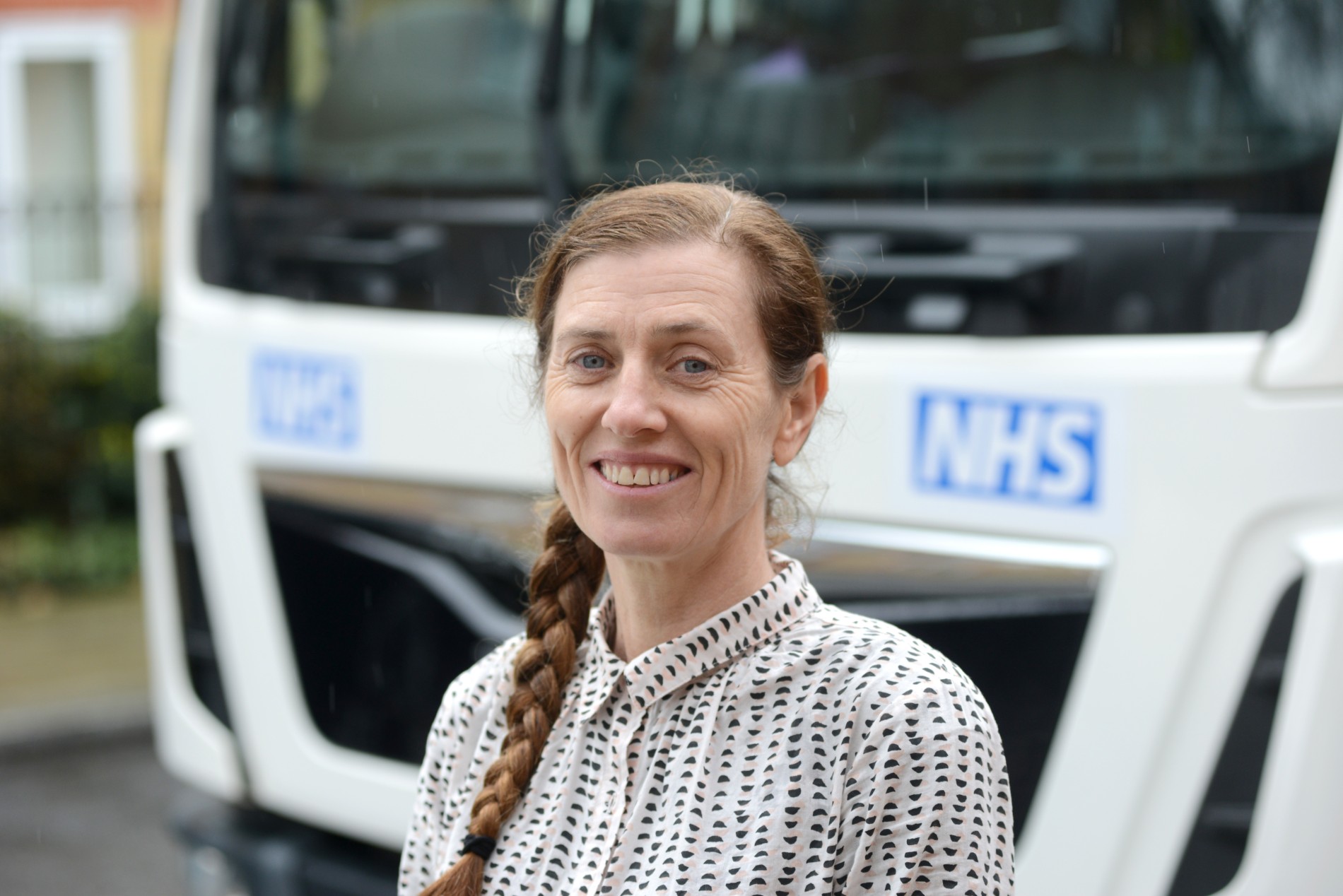 Nurse Yasmin in front of the mobile TB screening van