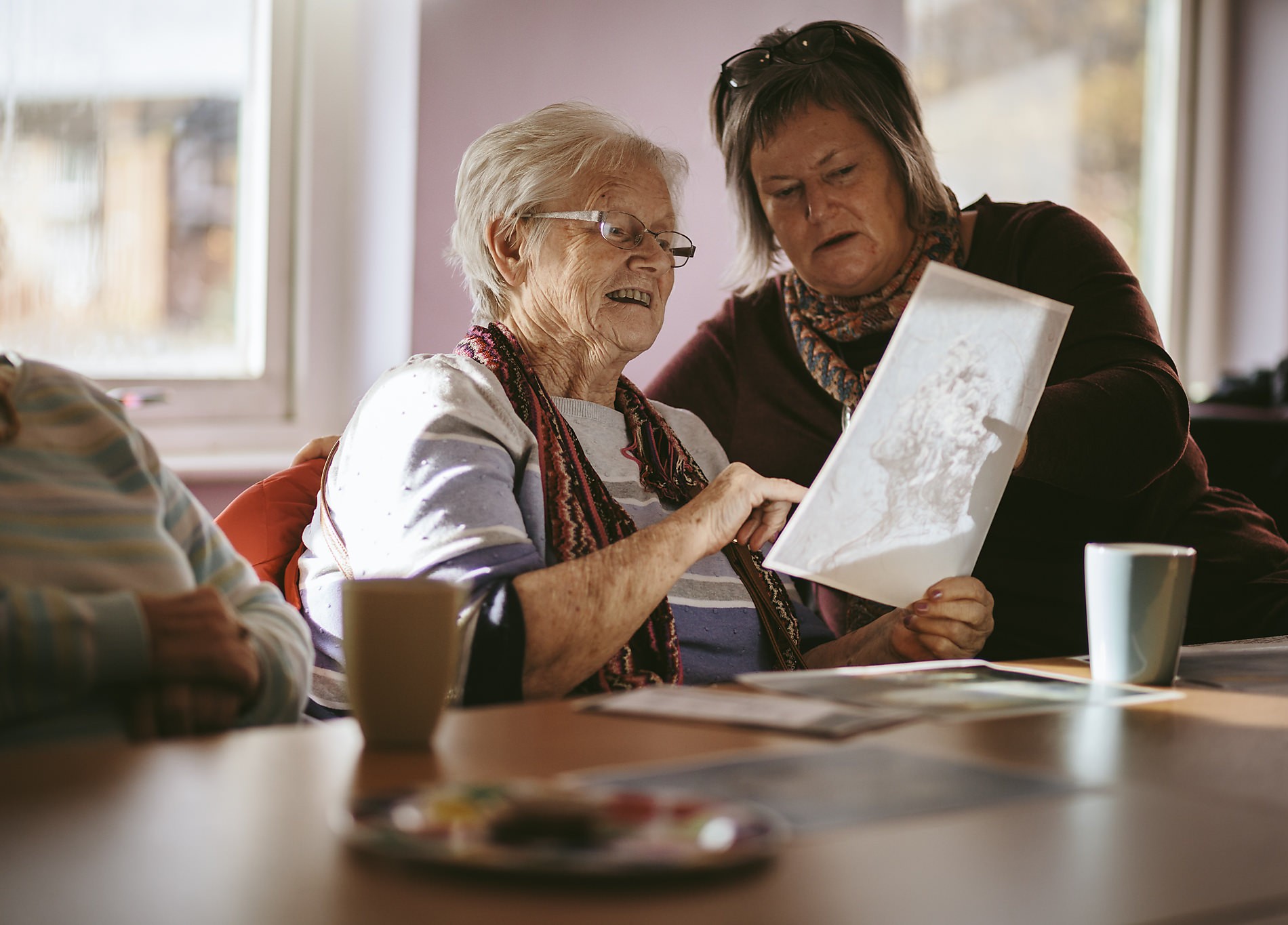 Two women take part in cultural outreach session for elderly with Northumbria University and TWAM (Tyne and Wear Archives and Museums) at Segedunum, Wallsend