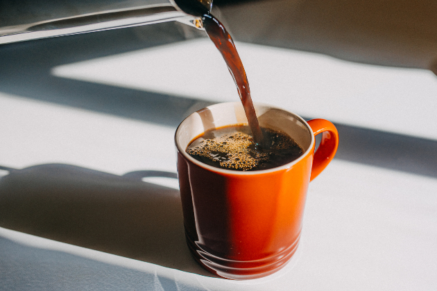 Cup of coffee being poured