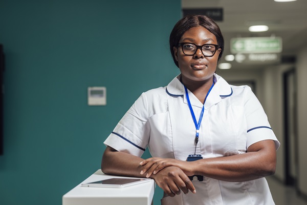 A member of nursing staff standing at a desk