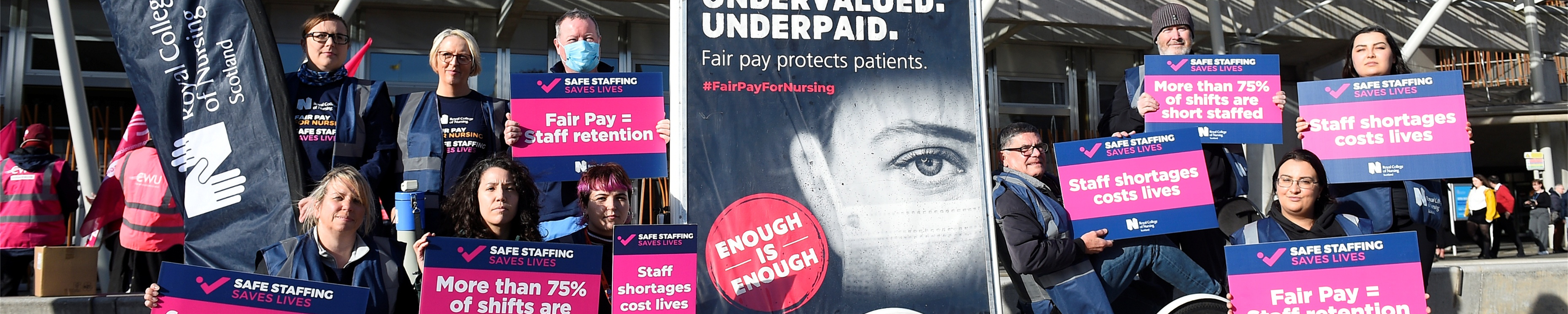 Nurses on a picket line with fair pay banners