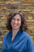 A photo of RCN Yorkshire & the Humber Professional Nursing Committee Member Anna Young. Anna is stood in front of a brick background smiling.